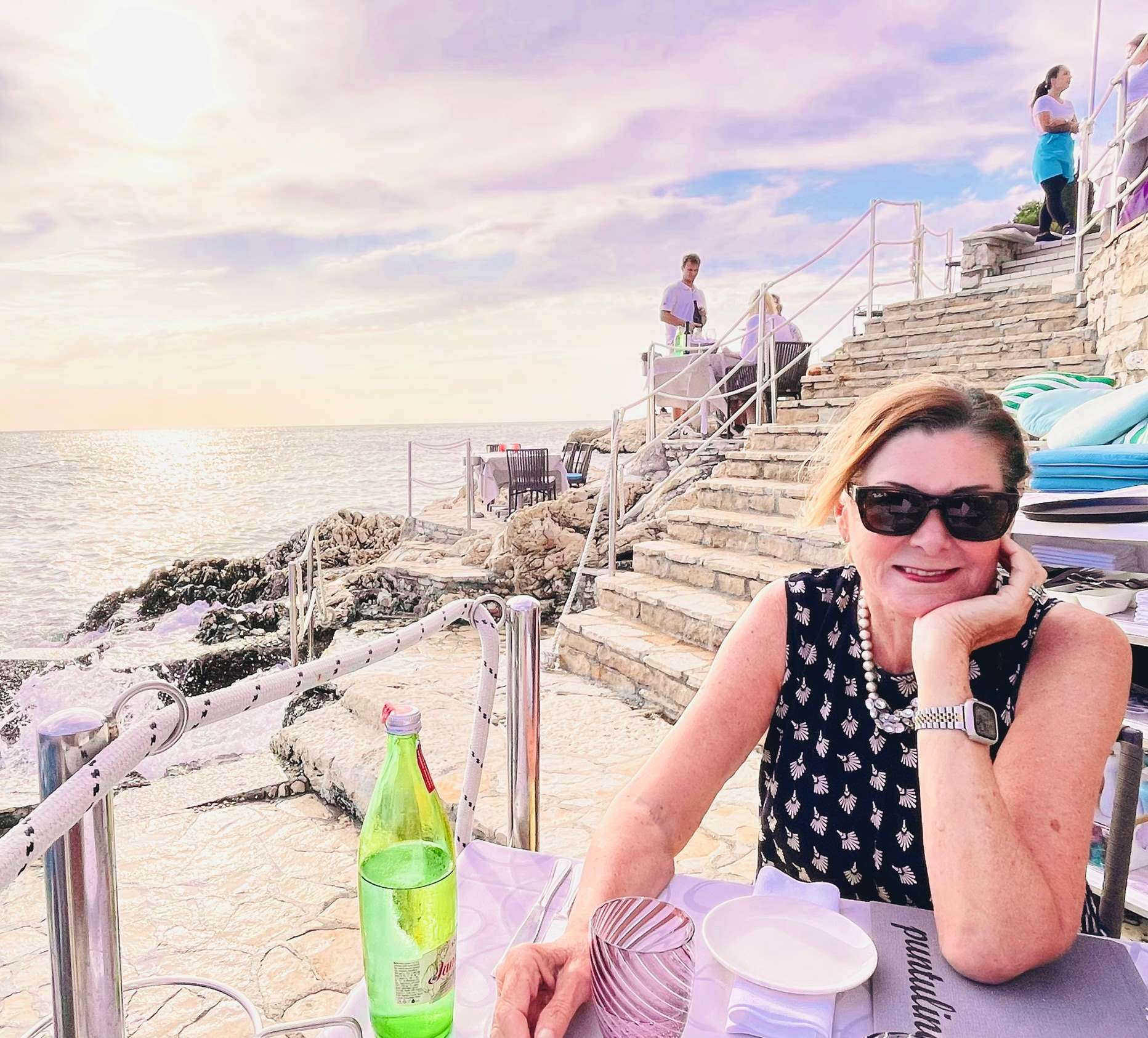 Robin dreaming about her table in this restaurant next to the stairs on the rocks in Rovinj, Croatia